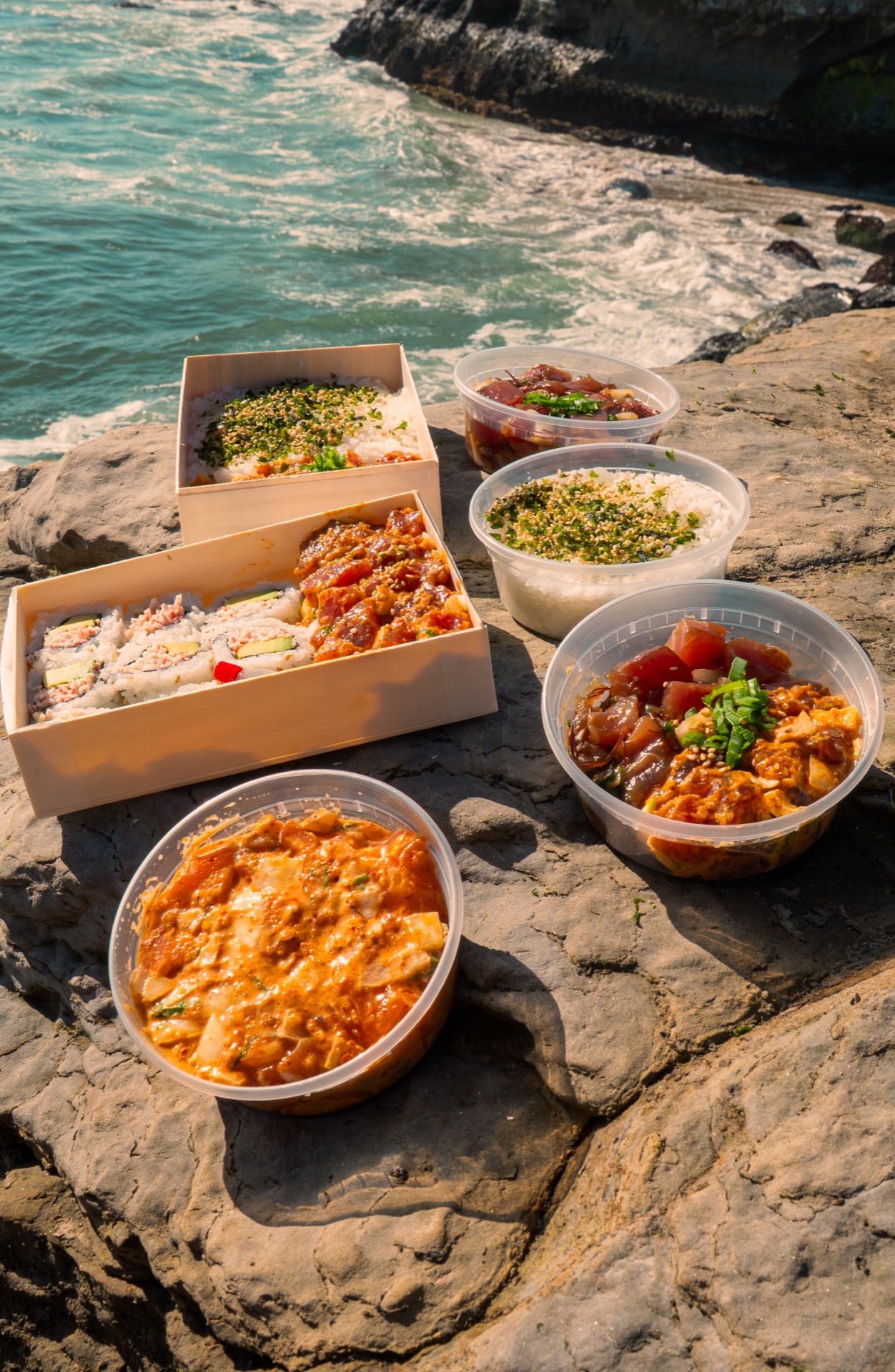 inoa poke bowls and sushi close-up on Santa Cruz rocks